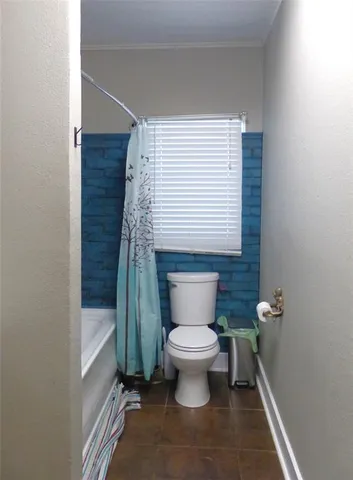 a bedroom with bed and a chandelier