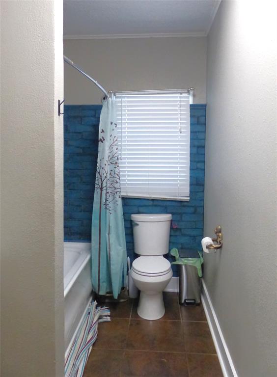 703 Gay Street Menard, TX 76859 - Photo 27 of 37 a bathroom with a toilet a sink and a bathtub