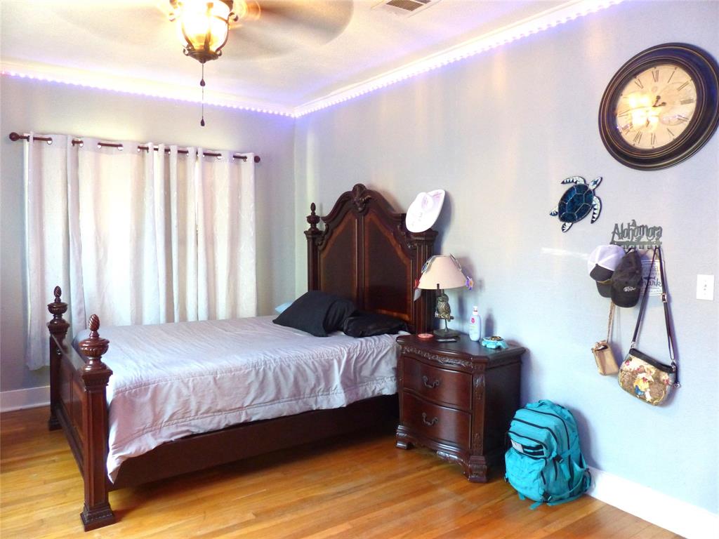 703 Gay Street Menard, TX 76859 - Photo 29 of 37 a bedroom with bed and a chandelier
