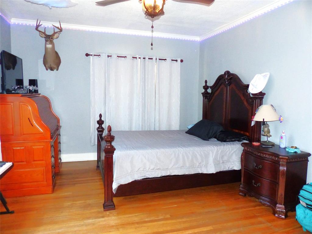 703 Gay Street Menard, TX 76859 - Photo 34 of 37 a bedroom with a bed and a mirror