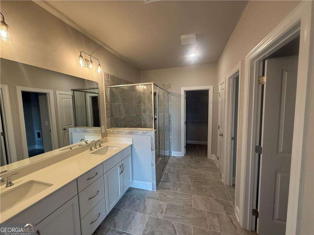 352 Lakeside Drive Canton, GA 30115 - Photo 10 of 16 a spacious bathroom with a double vanity sink and a mirror