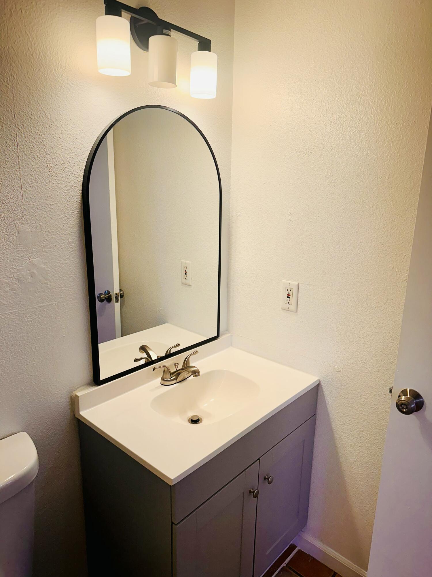 30880 Farr Road Visalia, CA 93291 - Photo 14 of 27 a bathroom with a sink and a mirror