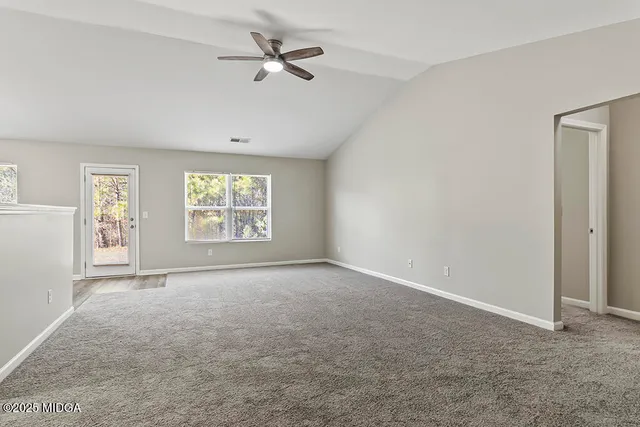 a view of a kitchen with a sink and a refrigerator