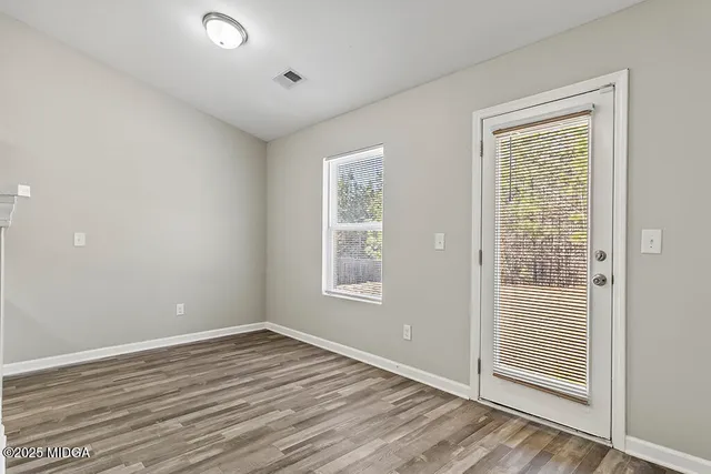 a kitchen with white cabinets and appliances