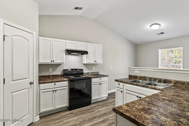 a kitchen with a sink stove and refrigerator