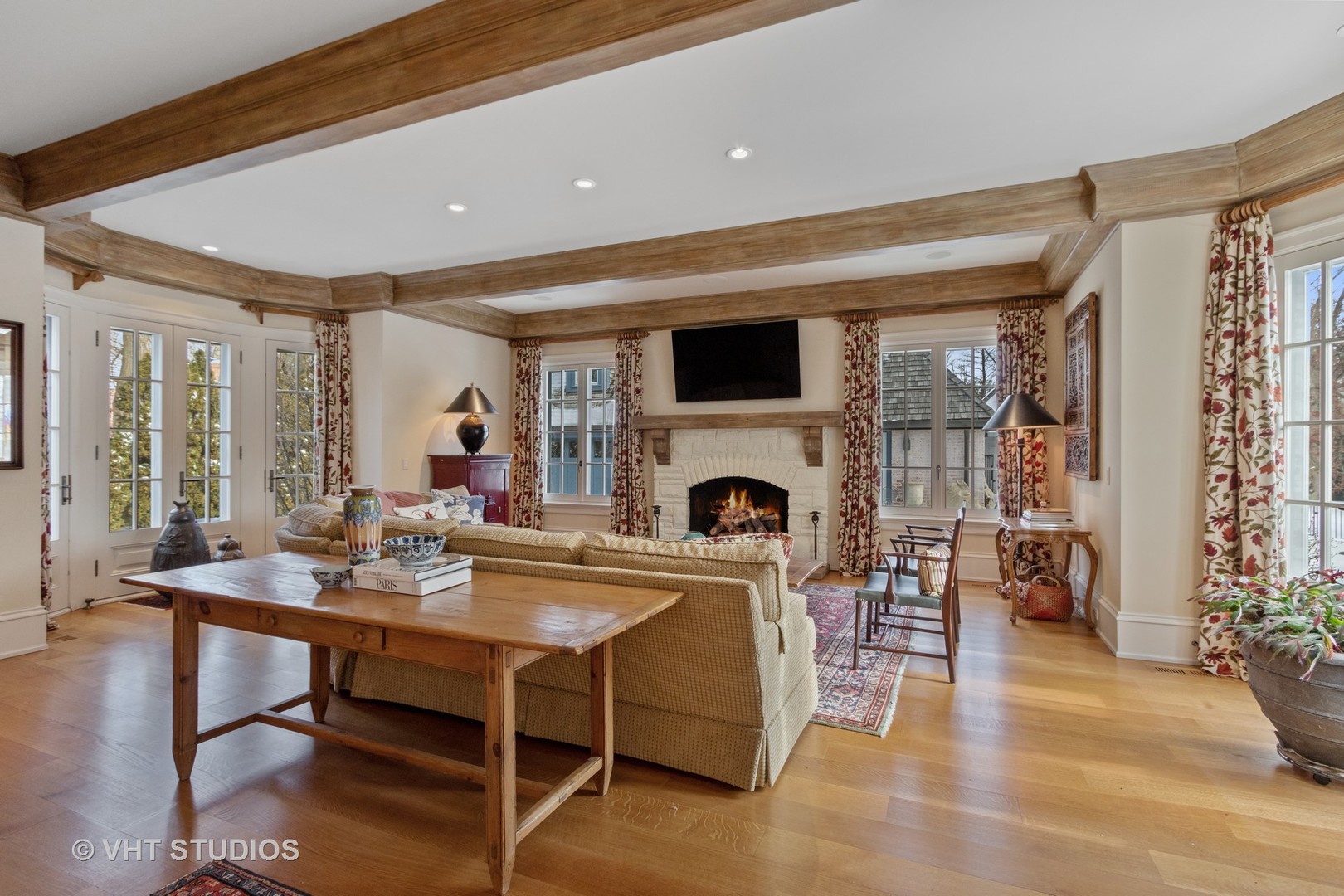 1291 Elm Tree Road Lake Forest, IL 60045 - Photo 16 of 56 a living room with furniture a fireplace and a table