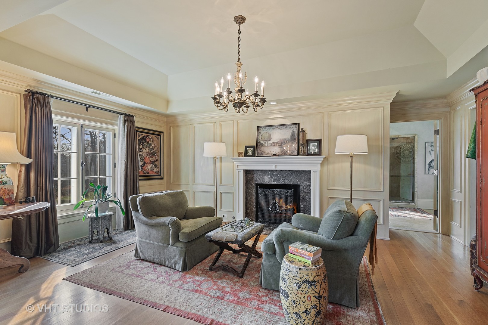 1291 Elm Tree Road Lake Forest, IL 60045 - Photo 20 of 56 a living room with furniture a chandelier and a fireplace
