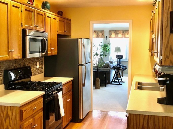 113 Ariel Circle, Unit 113 Sutton, MA 01590 - Photo 11 of 39 a kitchen with stainless steel appliances a stove refrigerator and a sink