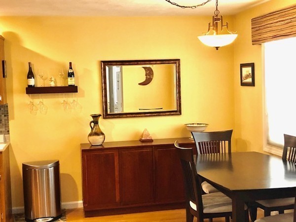 113 Ariel Circle, Unit 113 Sutton, MA 01590 - Photo 14 of 39 a view of a dining room with furniture and wooden floor