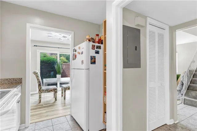 a view of kitchen with furniture and refrigerator