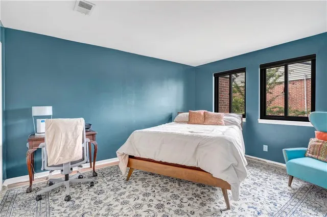 a bedroom with a bed and a window