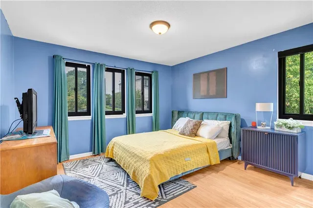 a bedroom with a bed and glass windows