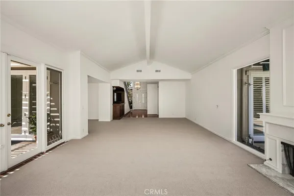 a view of a hallway with entryway wooden floor and cabinet