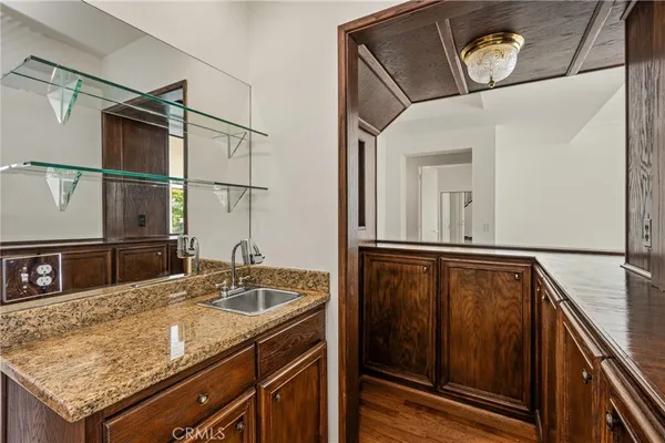 a kitchen with granite countertop cabinets sink and window