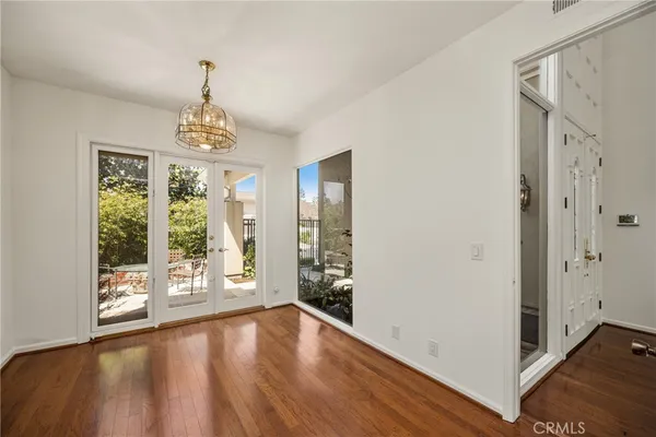 a view of a patio with table and chairs and floor to ceiling window