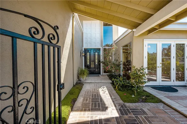 a view of a front door and potted plants