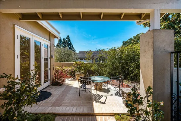 a view of a patio with couches table and chairs and potted plants
