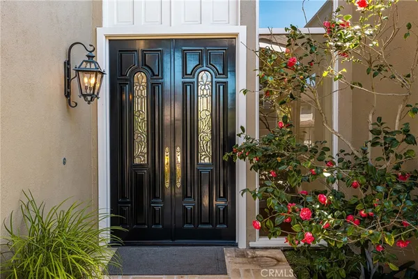 a front view of a house with a flower garden