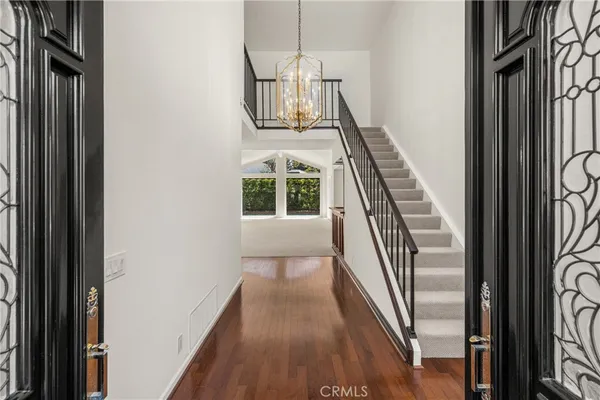 a view of entryway and hall with wooden floor