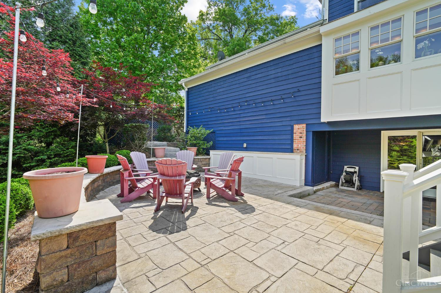 2780 Walsh Road Cincinnati, OH 45208 - Photo 52 of 68 The lower outdoor living areas are thoughtfully designed for both relaxation and entertaining, featuring two distinct patio spaces. A stamped concrete patio offers an attractive, low-maintenance setting ideal for gatherings, while the paver patio tucked beneath the deck creates a more private retreat, complete with a hot tub for year-round enjoyment. Together, these spaces provide a versatile extension of the home, perfect for both lively entertaining and quiet moments outdoors.