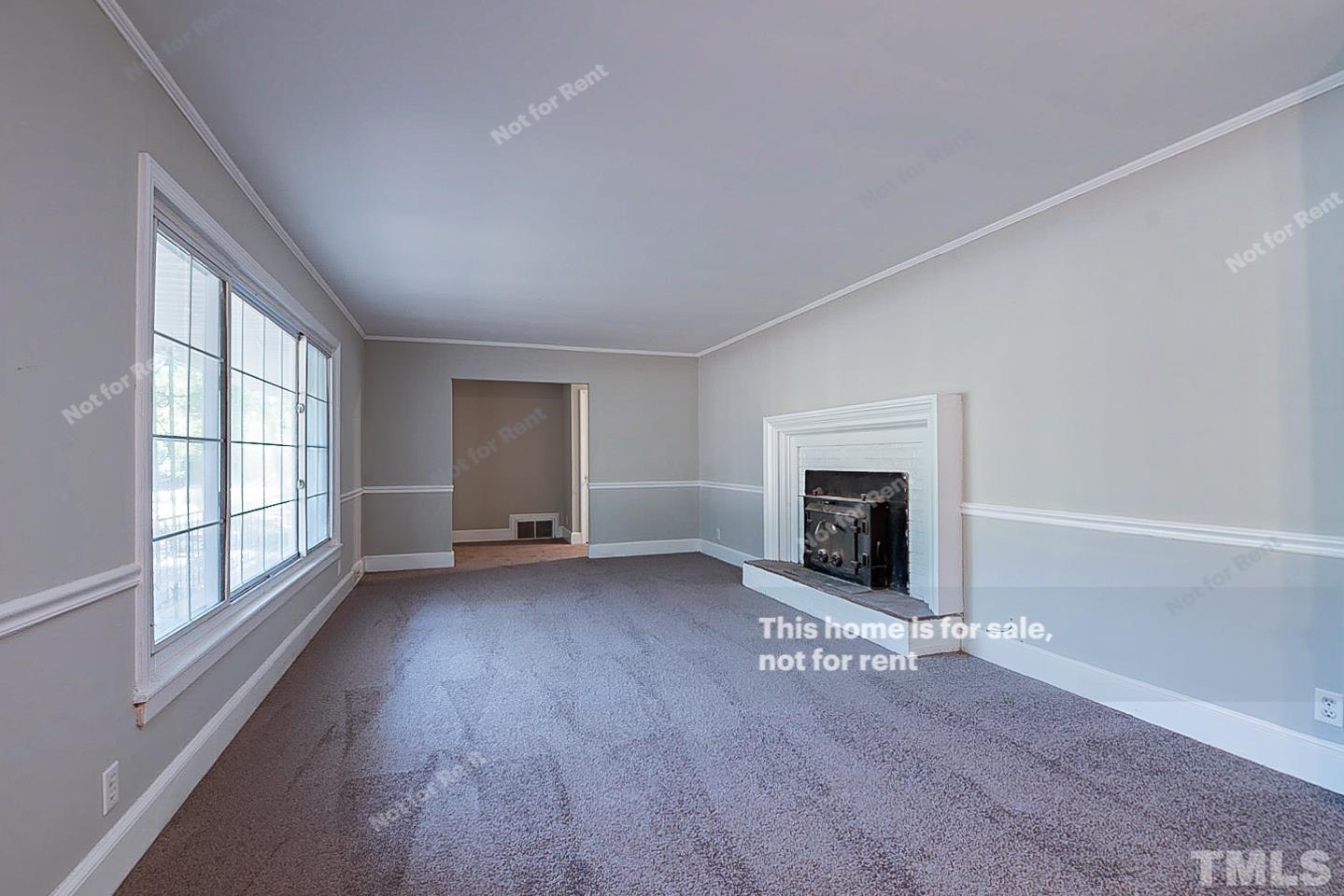116 Ridge Road Butner, NC 27509 - Photo 3 of 16 wooden floor fireplace and windows in an empty room