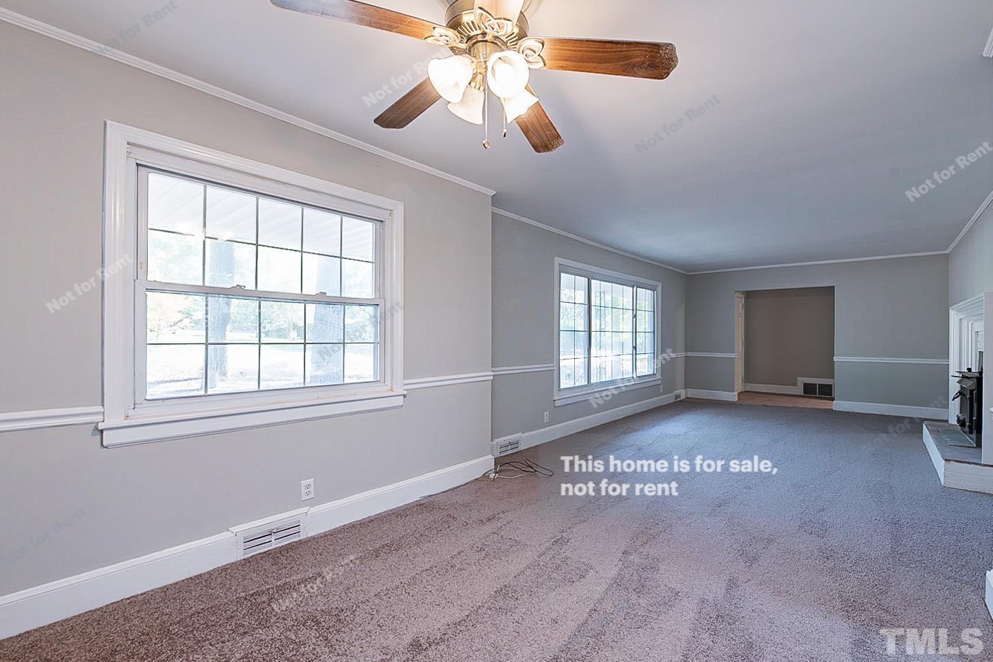 116 Ridge Road Butner, NC 27509 - Photo 9 of 16 an empty room with chandelier fan and windows