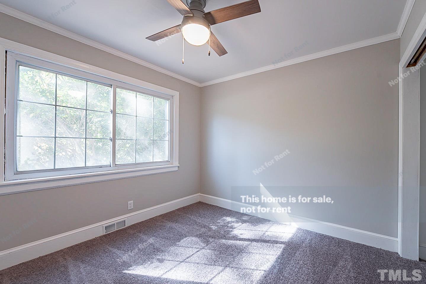 116 Ridge Road Butner, NC 27509 - Photo 10 of 16 a view of an empty room with a window