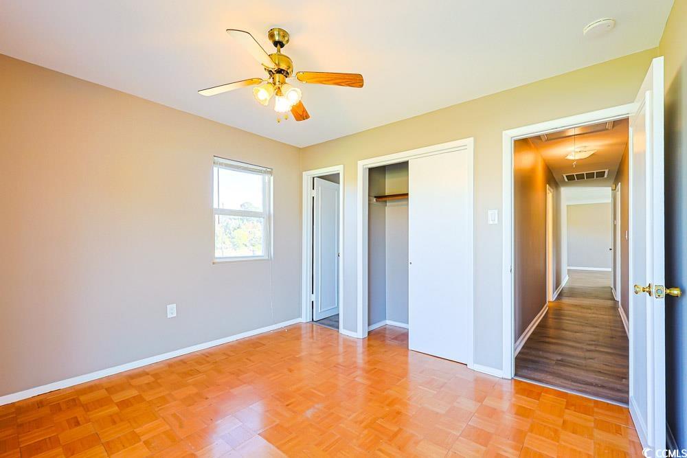 200 Math Place Little River, SC 29566 - Photo 13 of 40 Unfurnished bedroom with attic access, ceiling fan, a closet, and parquet floors