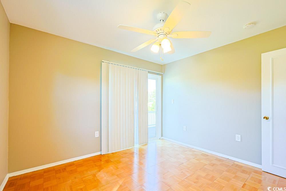 200 Math Place Little River, SC 29566 - Photo 19 of 40 Unfurnished bedroom featuring a ceiling fan and access to exterior