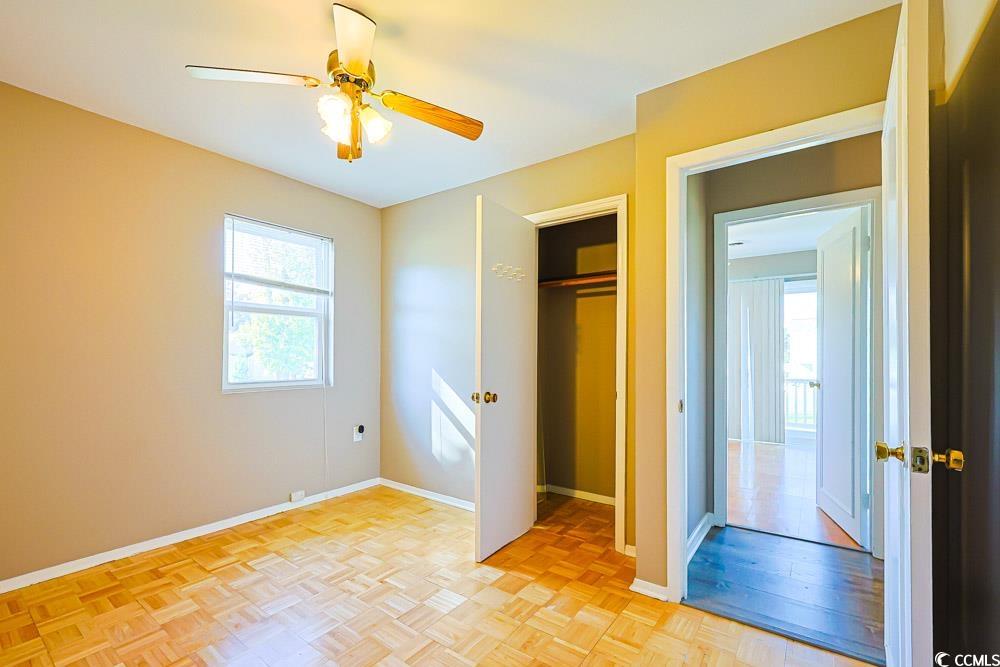 200 Math Place Little River, SC 29566 - Photo 20 of 40 Unfurnished bedroom featuring a closet, ceiling fan, and parquet flooring