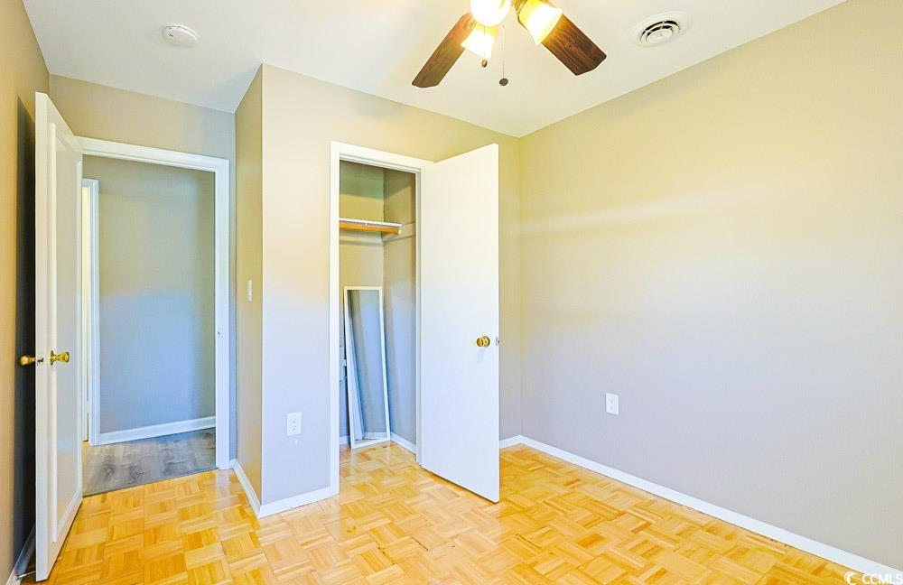 200 Math Place Little River, SC 29566 - Photo 23 of 40 Unfurnished bedroom featuring a ceiling fan and a closet