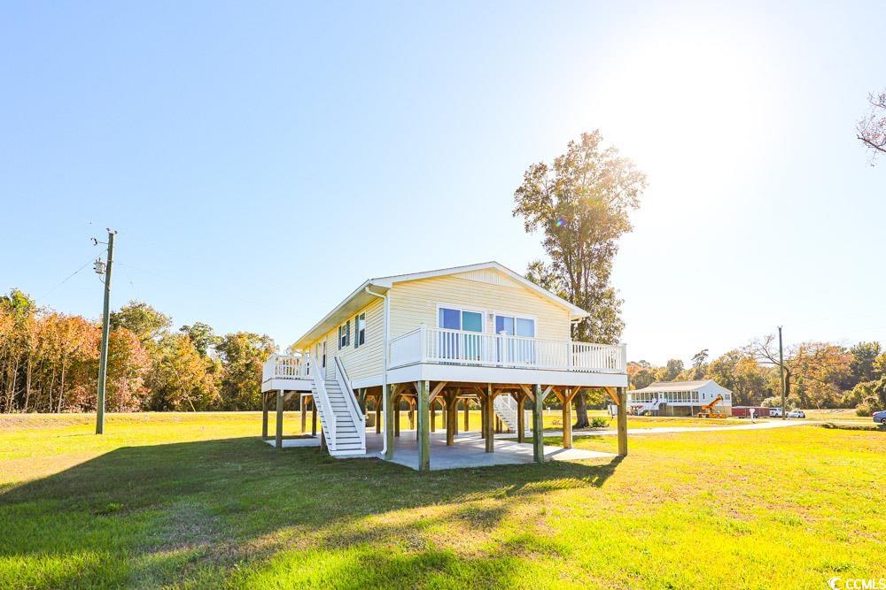 200 Math Place Little River, SC 29566 - Photo 27 of 40 Back of property featuring a yard, a wooden deck, a patio area, and stairs