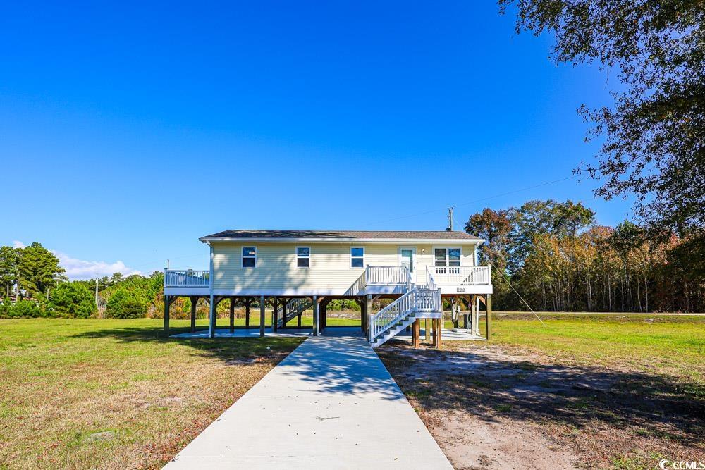 200 Math Place Little River, SC 29566 - Photo 33 of 40 Rear view of house featuring a yard, a deck, a carport, stairway, and concrete driveway
