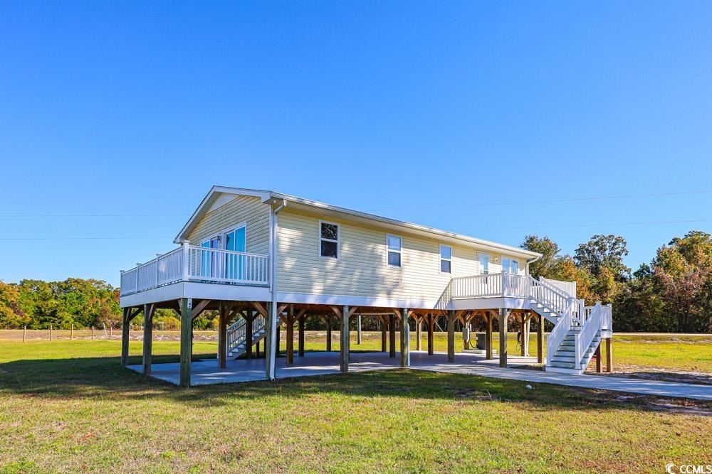 200 Math Place Little River, SC 29566 - Photo 40 of 40 Rear view of house featuring stairway, a yard, and a deck