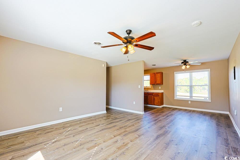 200 Math Place Little River, SC 29566 - Photo 4 of 40 Unfurnished living room featuring light wood-type flooring and a ceiling fan