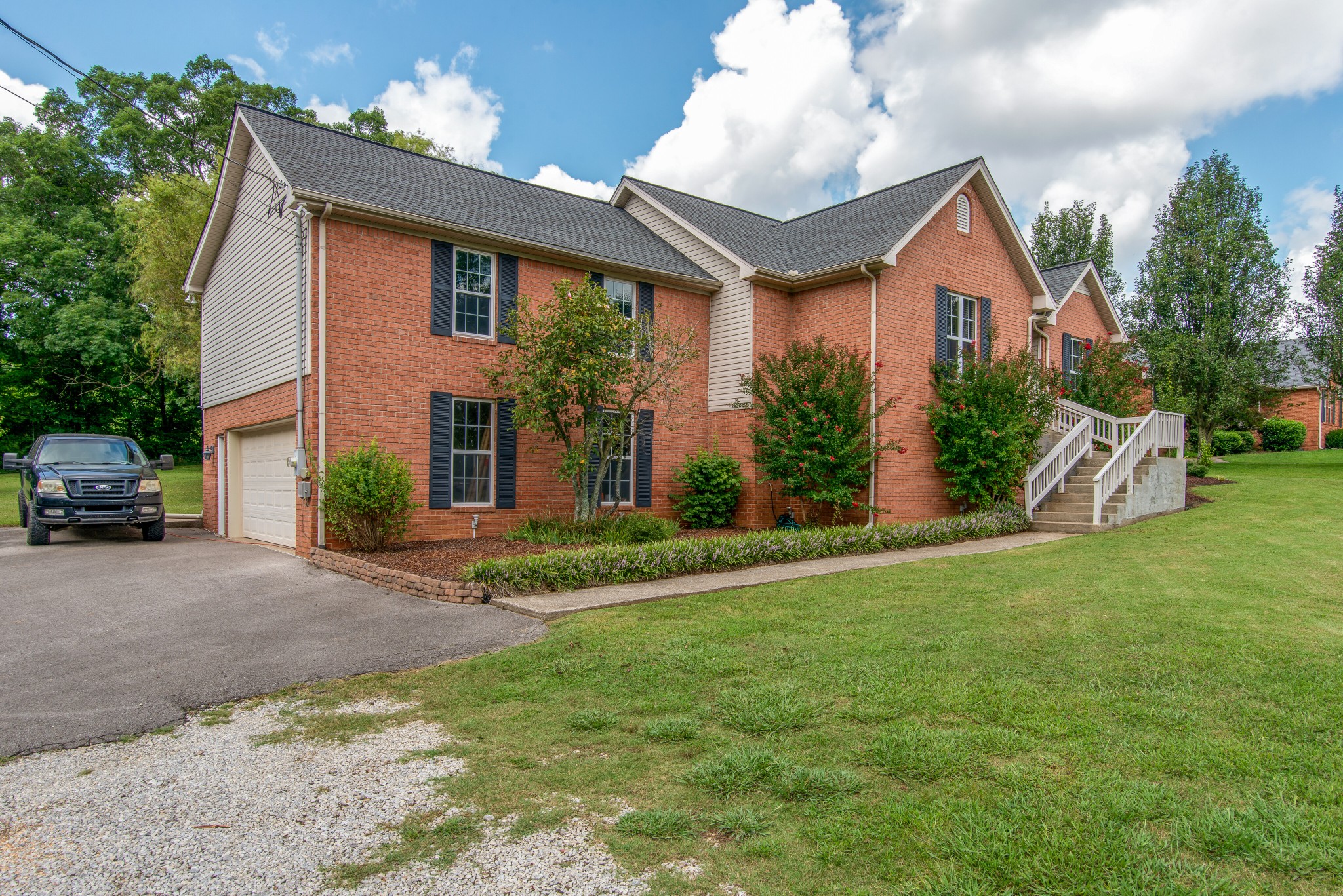 2696 Oak Grove Road Lebanon, TN 37090 - Photo 2 of 34 a front view of a house with a yard and garage