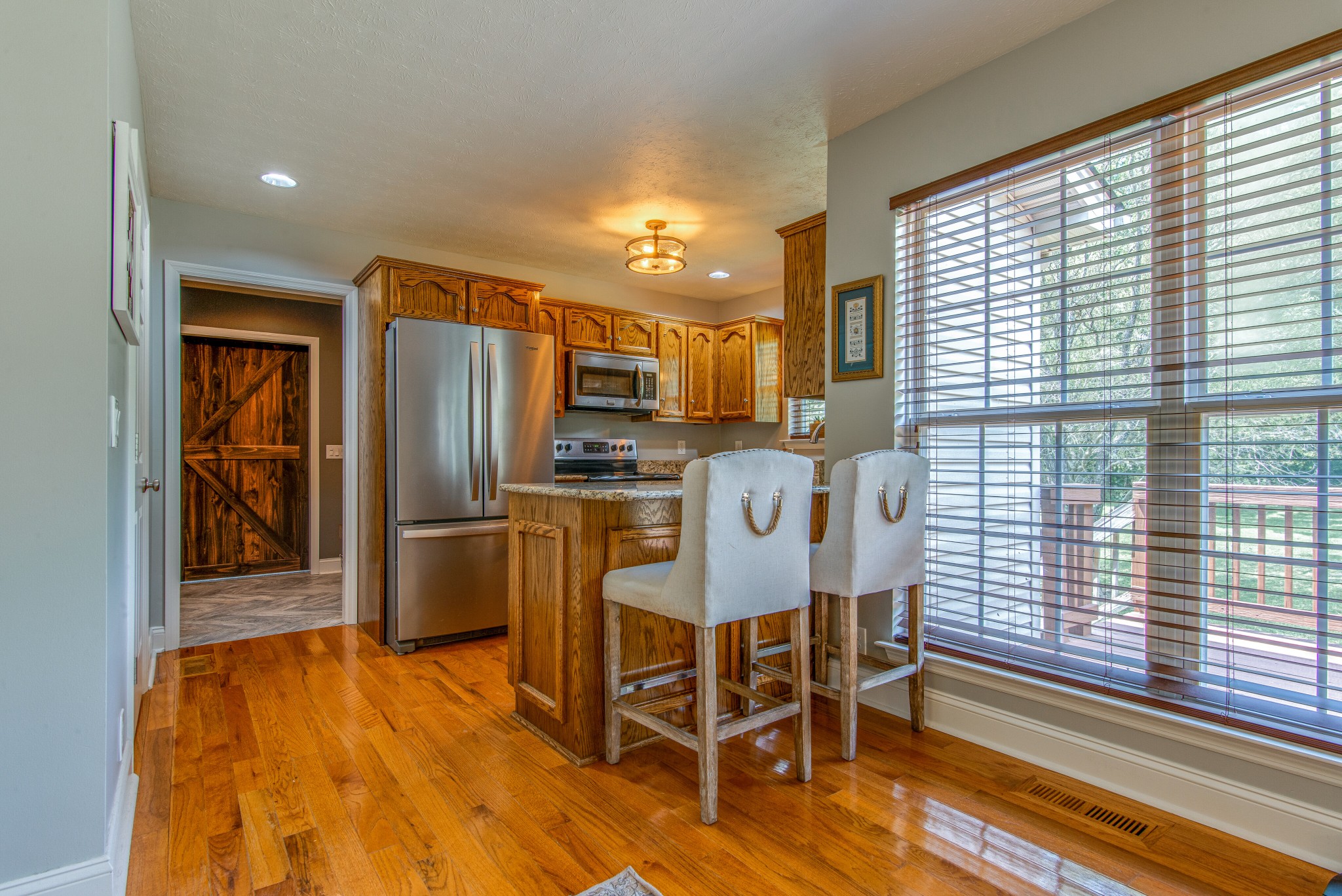 2696 Oak Grove Road Lebanon, TN 37090 - Photo 11 of 34 a dining room with stainless steel appliances a refrigerator and a kitchen island
