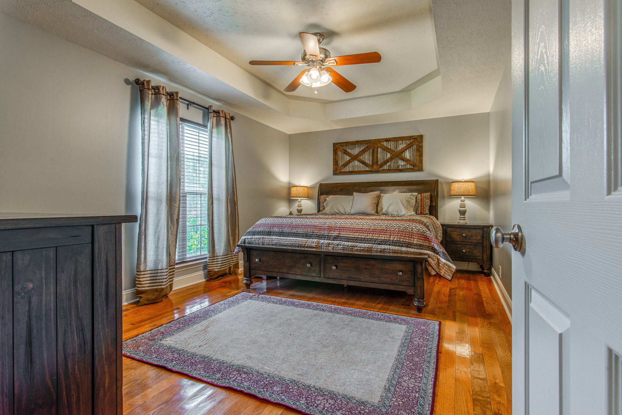 2696 Oak Grove Road Lebanon, TN 37090 - Photo 15 of 34 a bedroom with a bed and a chandelier
