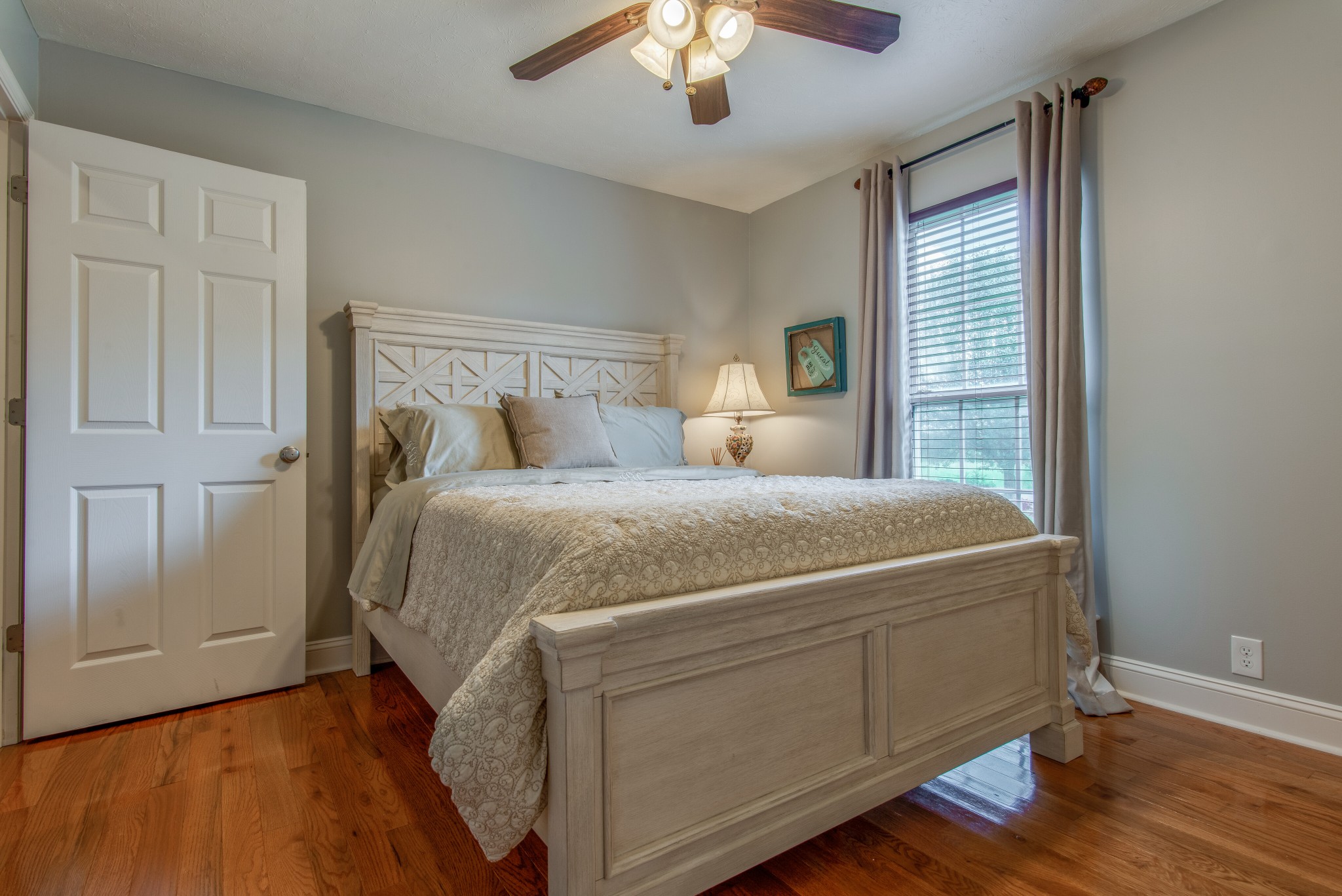2696 Oak Grove Road Lebanon, TN 37090 - Photo 21 of 34 a bed sitting in a bedroom next to a window and a chandelier