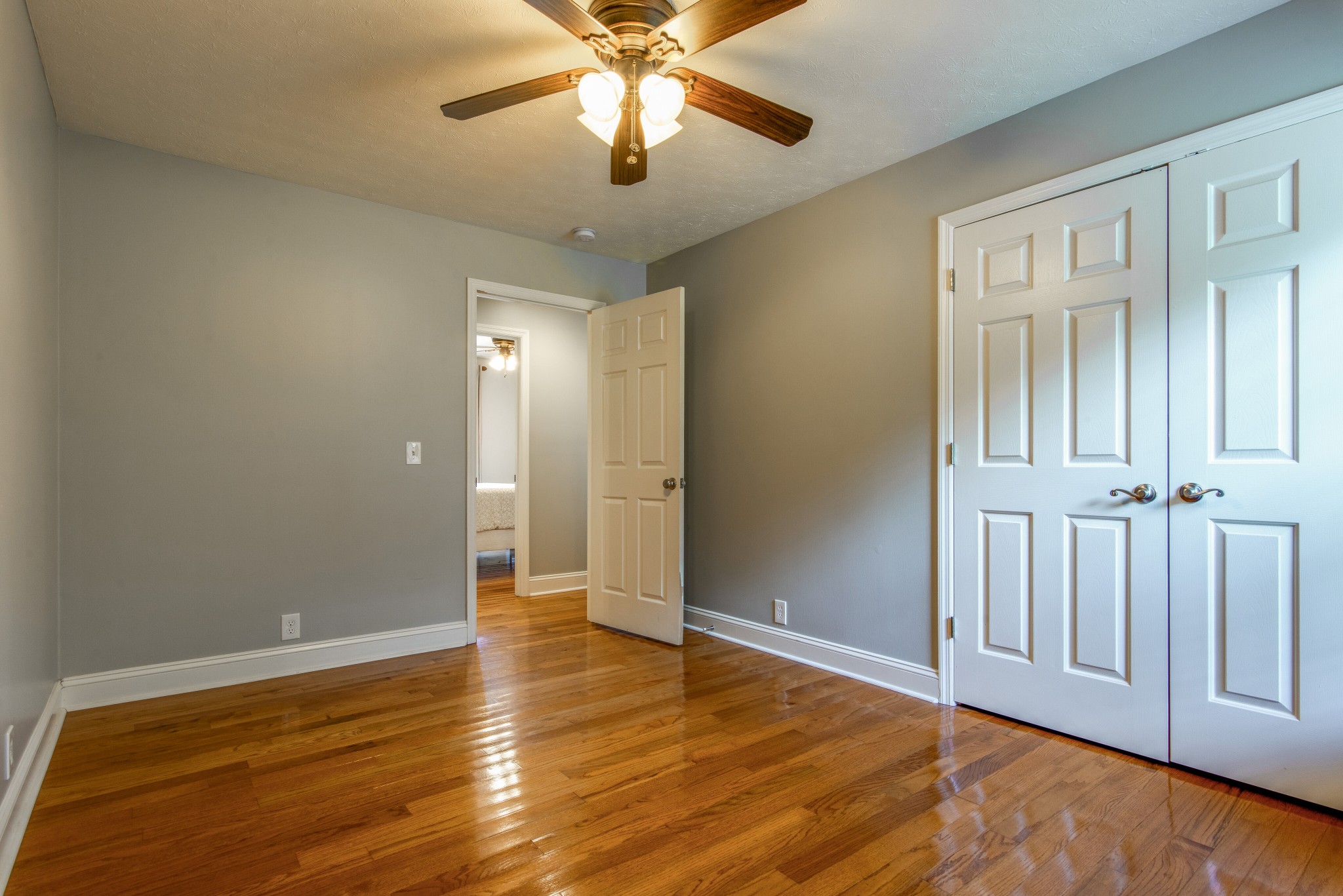 2696 Oak Grove Road Lebanon, TN 37090 - Photo 23 of 34 an empty room with wooden floor chandelier fan and windows
