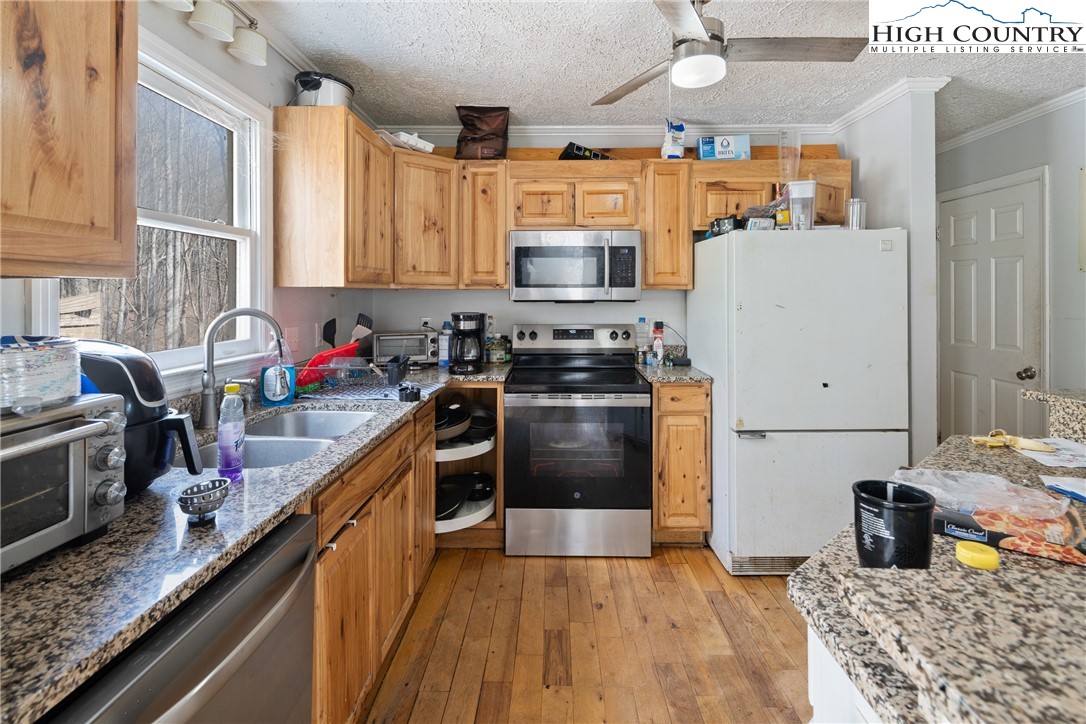 656 Winterberry Trail Boone, NC 28607 - Photo 12 of 47 a kitchen with stainless steel appliances granite countertop a sink stove and refrigerator