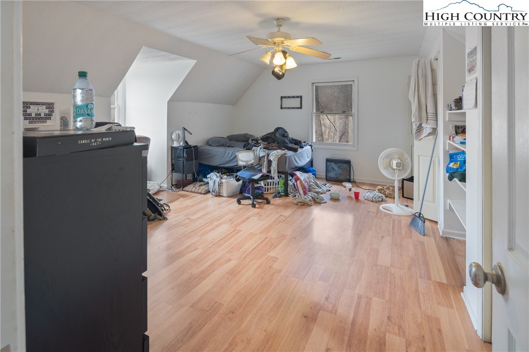 656 Winterberry Trail Boone, NC 28607 - Photo 23 of 47 a living room with furniture a chandelier and a dining table