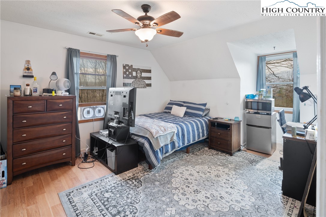 656 Winterberry Trail Boone, NC 28607 - Photo 26 of 47 a bedroom with a bed a dresser and potted plant with the dresser