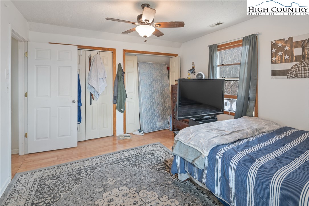 656 Winterberry Trail Boone, NC 28607 - Photo 27 of 47 a bedroom with a bed and a chandelier