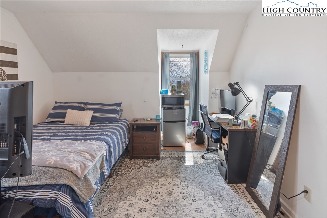 656 Winterberry Trail Boone, NC 28607 - Photo 28 of 47 a bedroom with a bed and wooden floor