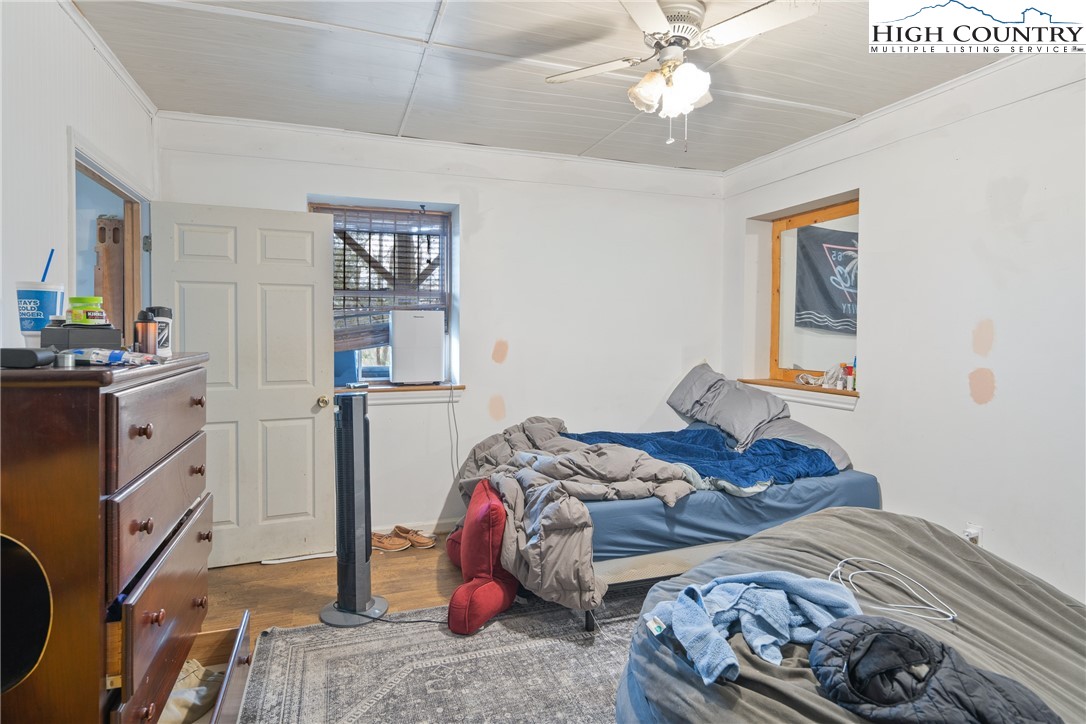 656 Winterberry Trail Boone, NC 28607 - Photo 38 of 47 a bedroom with bed and a chandelier