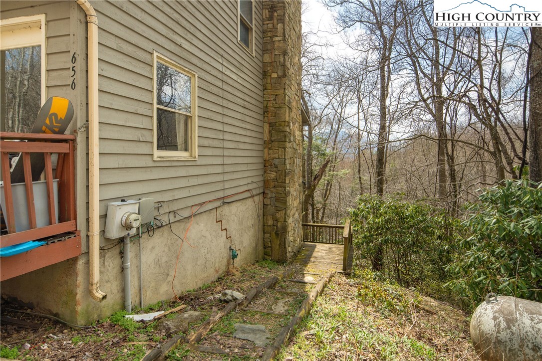 656 Winterberry Trail Boone, NC 28607 - Photo 5 of 47 a view of a porch with plants and wooden fence