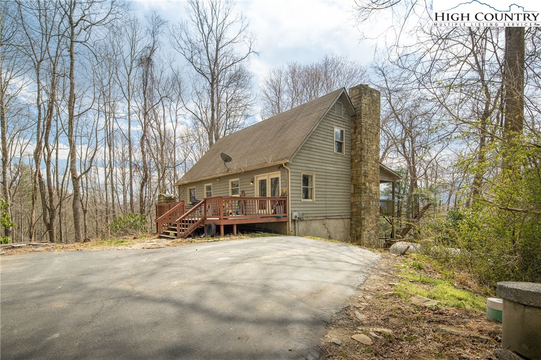 656 Winterberry Trail Boone, NC 28607 - Photo 6 of 47 a view of a house with a yard covered in snow