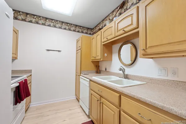 a bathroom with a sink a mirror and a shower curtain