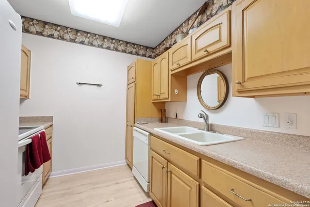 a bathroom with a sink a mirror and a shower curtain